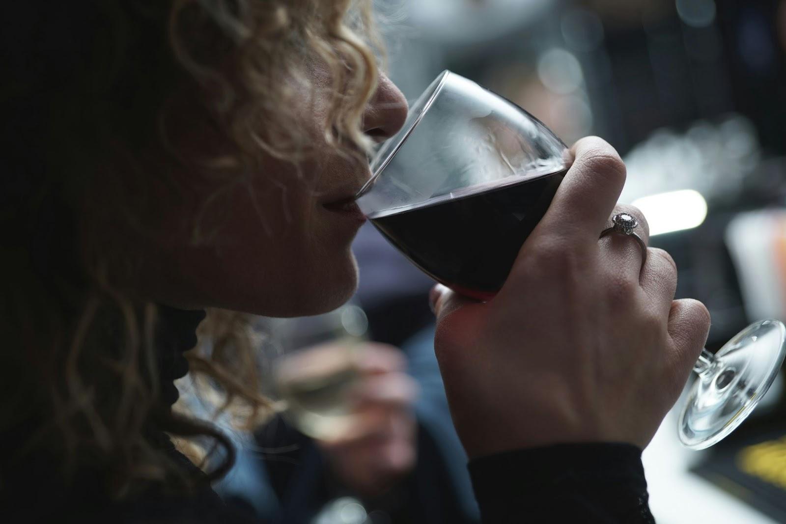 A woman sipping wine