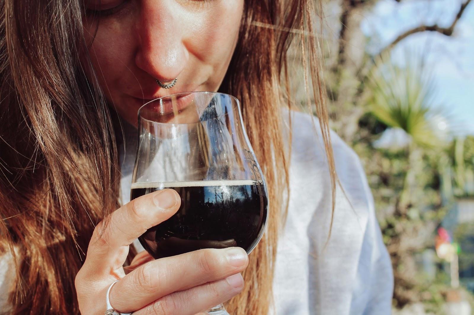 A woman smelling the wine