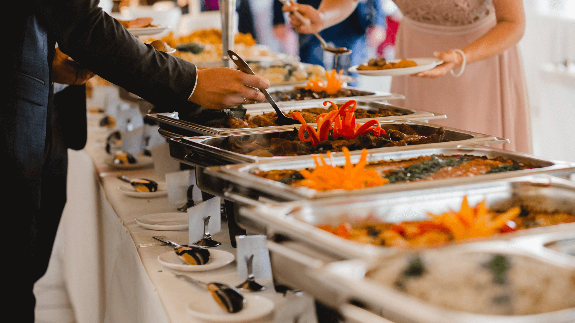 Guests serving themselves in a buffet wedding